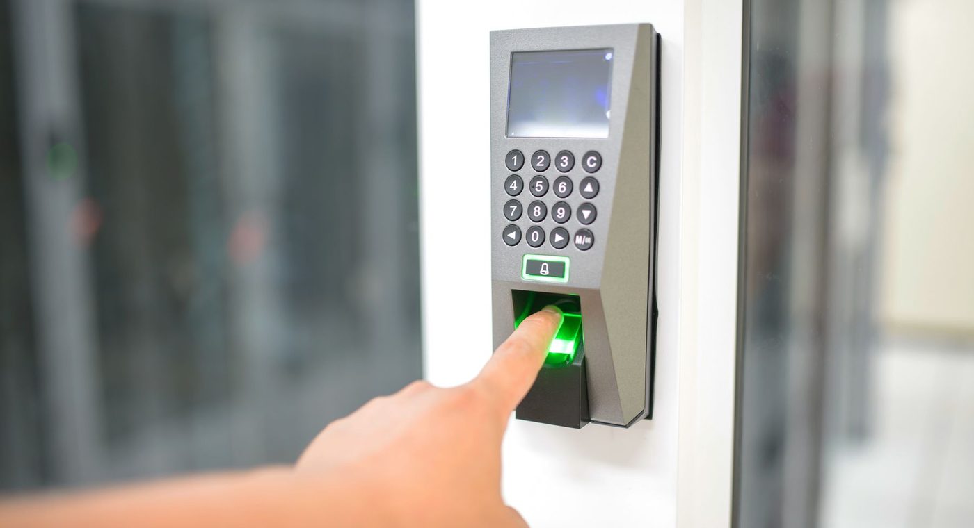 A keypad and card reader mounted beside a commercial door