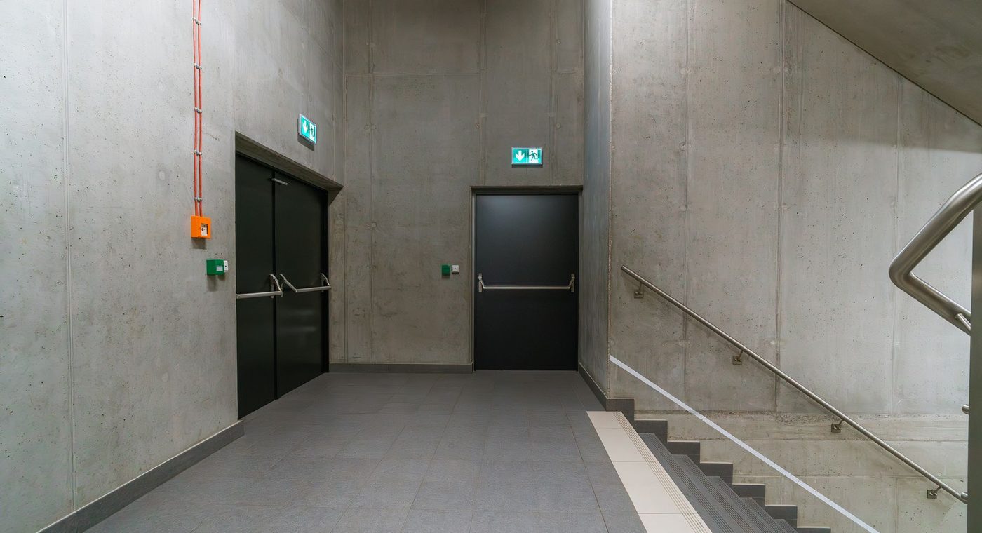 A labeled fire-rated steel door and frame in a building corridor