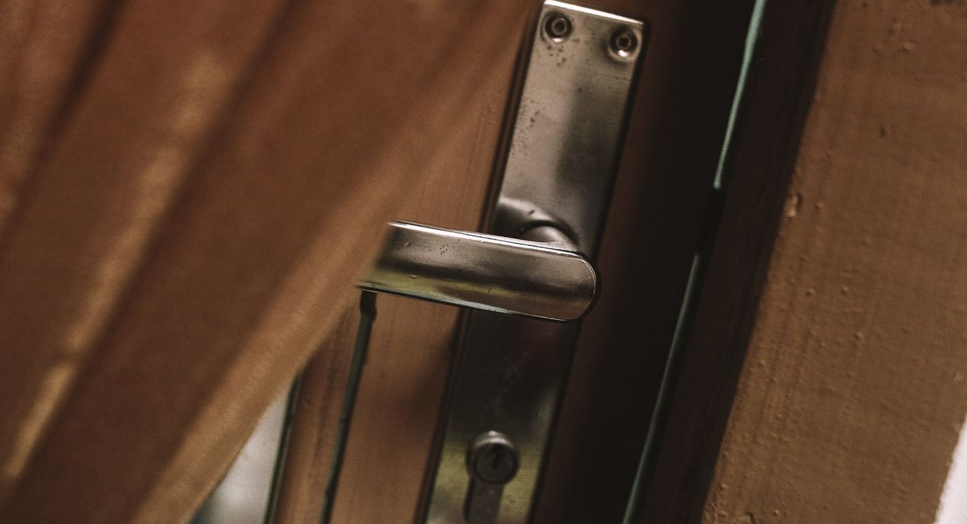 The existing mortise lock on a commercial door being checked before an electric strike is chosen